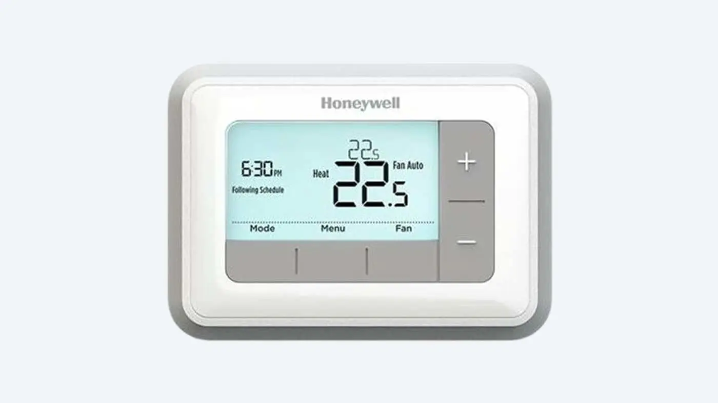 Honeywell digital thermostat showing 22.5°C temperature, heat mode active, 6:30 PM time, with plus/minus control buttons.