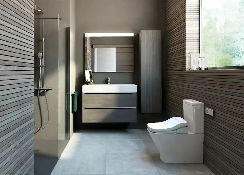 Modern bathroom with gray wood paneling, glass shower, floating vanity, illuminated mirror, and white toilet.