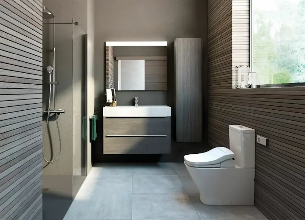 Modern bathroom with gray wood paneling, glass shower, floating vanity, illuminated mirror, and white toilet.