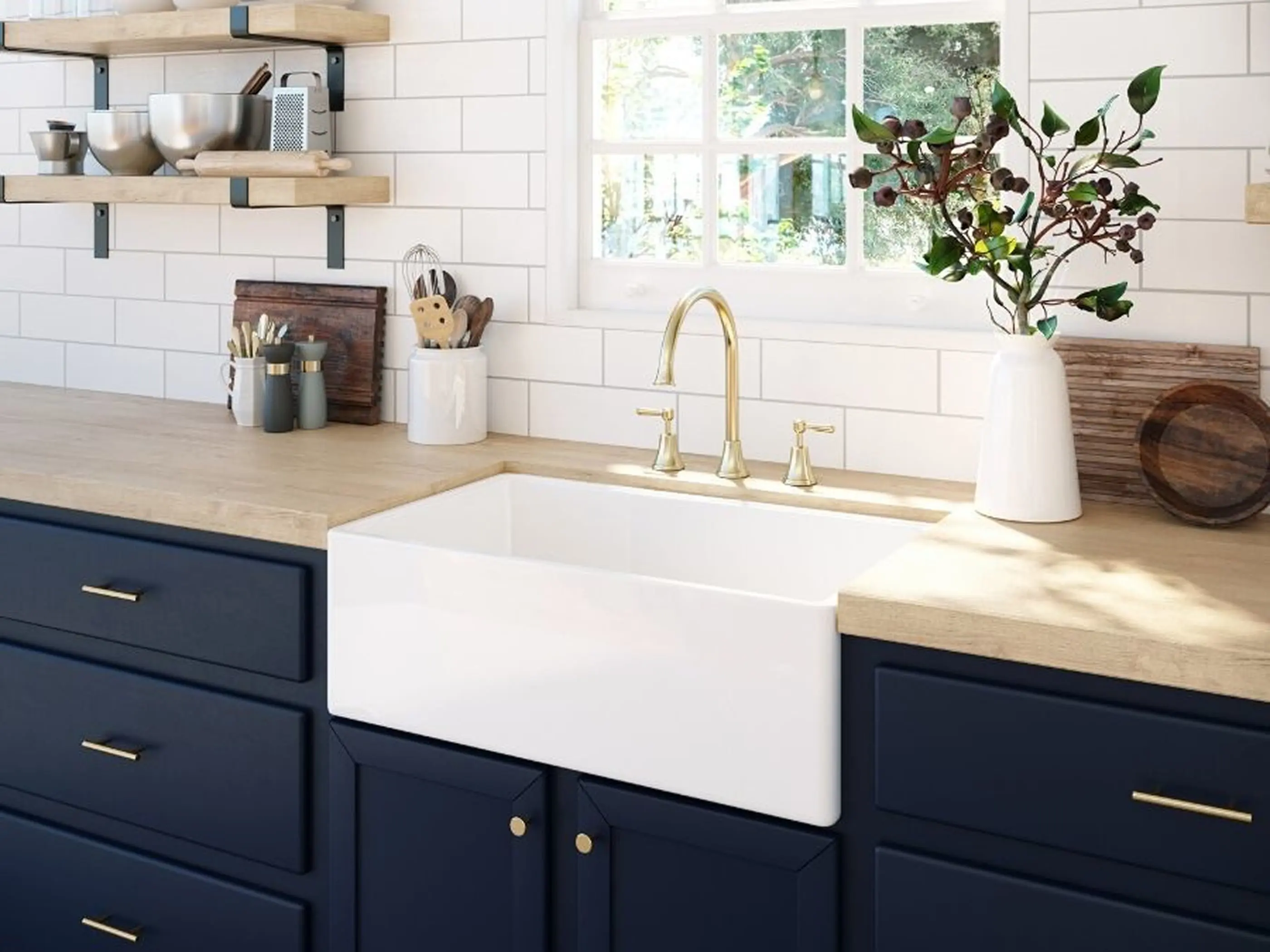 Modern kitchen with white farmhouse sink, navy cabinets, wooden countertops, brass faucet, and open shelving.