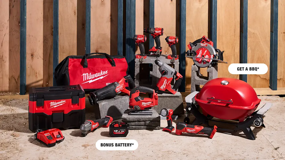 Milwaukee power tools collection including drills, saw, and vacuum displayed with a red BBQ grill and tool bag.