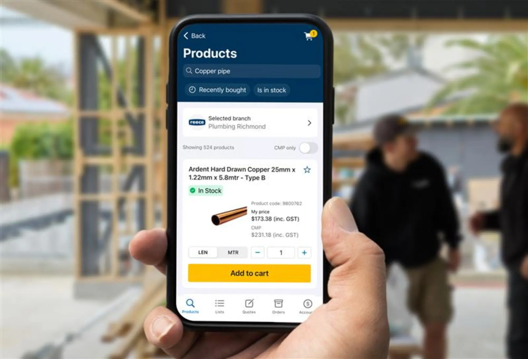 Smartphone displaying a product page for Kembla copper tubes with price and "Add to cart" button at a construction site.