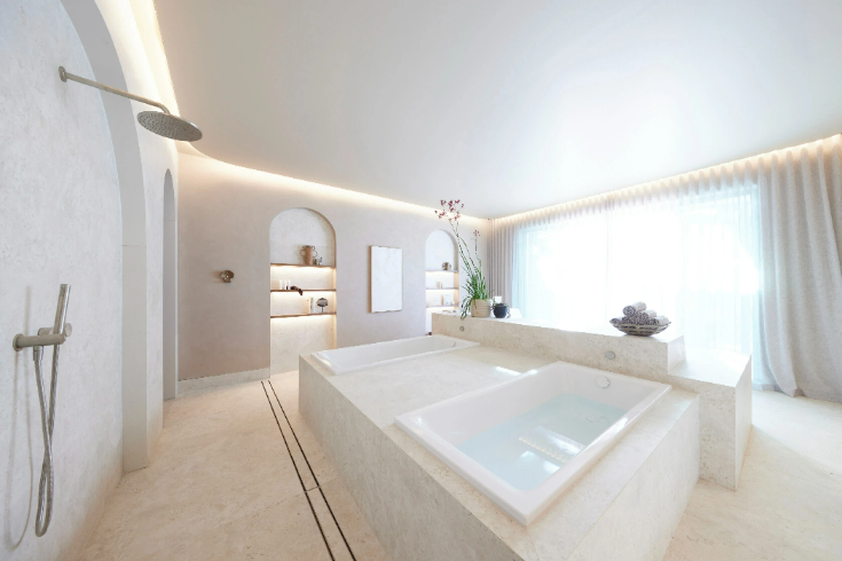 Minimalist white bathroom with built-in bathtub, rainfall shower, recessed lighting, and sheer curtains covering a large window.
