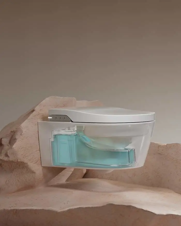 Modern white toilet with transparent blue water tank displayed on beige textured surface.