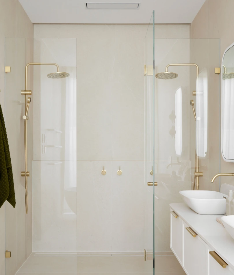 Modern bathroom with glass shower, beige tiles, gold fixtures, white vessel sink, and minimalist design.