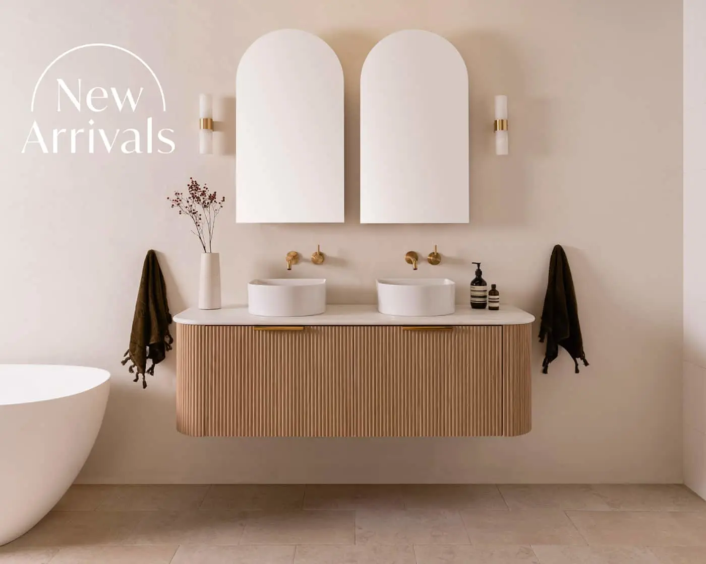 Modern bathroom with floating wooden vanity, dual white vessel sinks, arched mirrors, and "New Arrivals" text overlay.