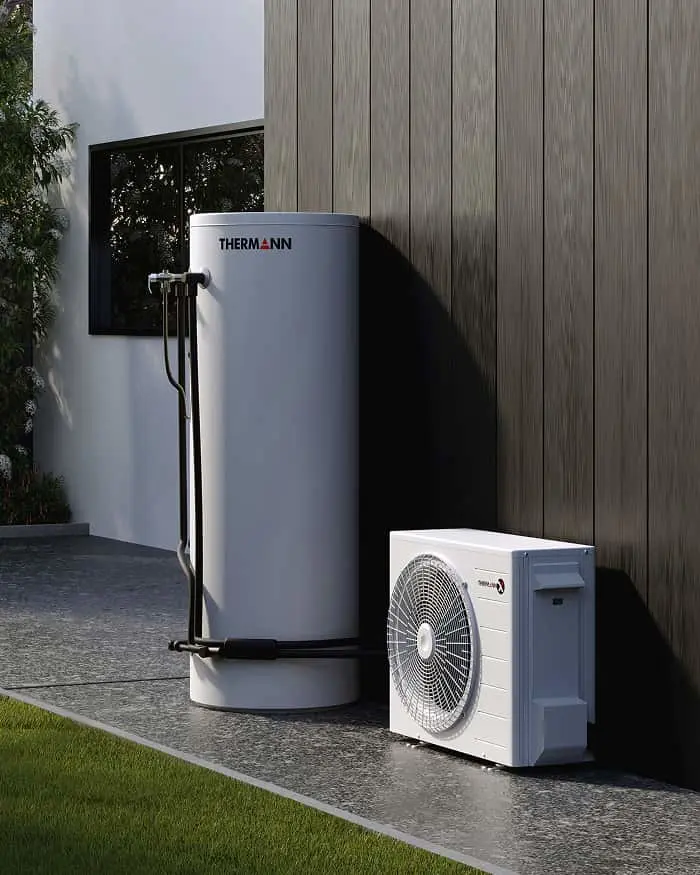 Thermann heat pump system with cylindrical water tank and outdoor condenser unit installed beside modern home.