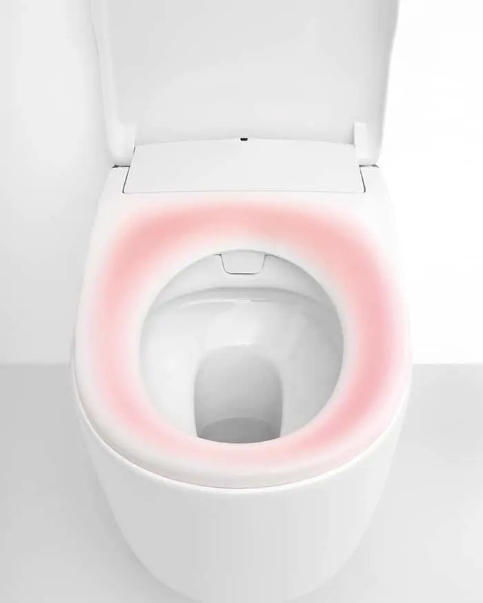 White toilet with open lid showing pink illuminated rim around the bowl interior.