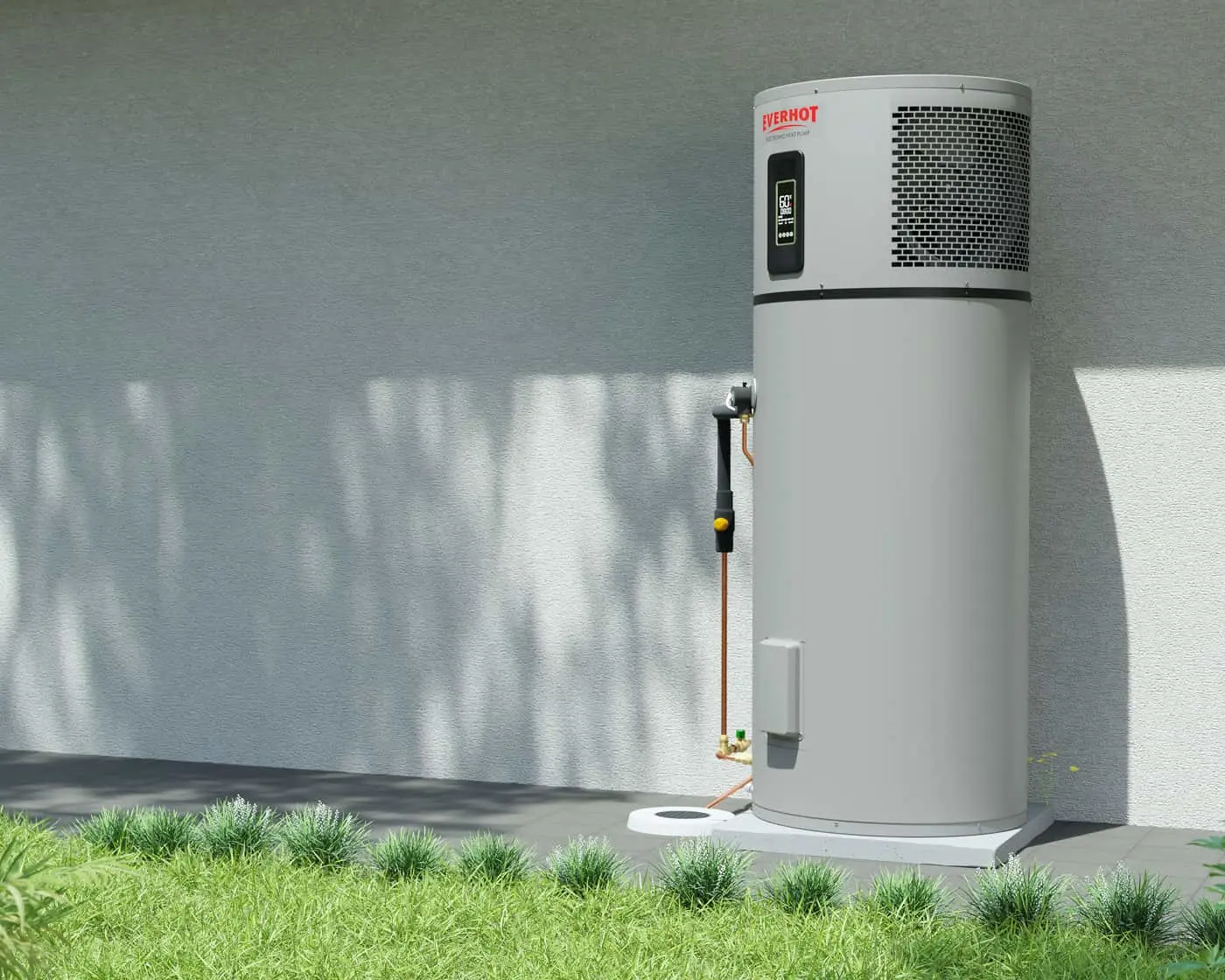 Everhot water heater installed outside a gray wall, with digital display and copper pipes on green grass.