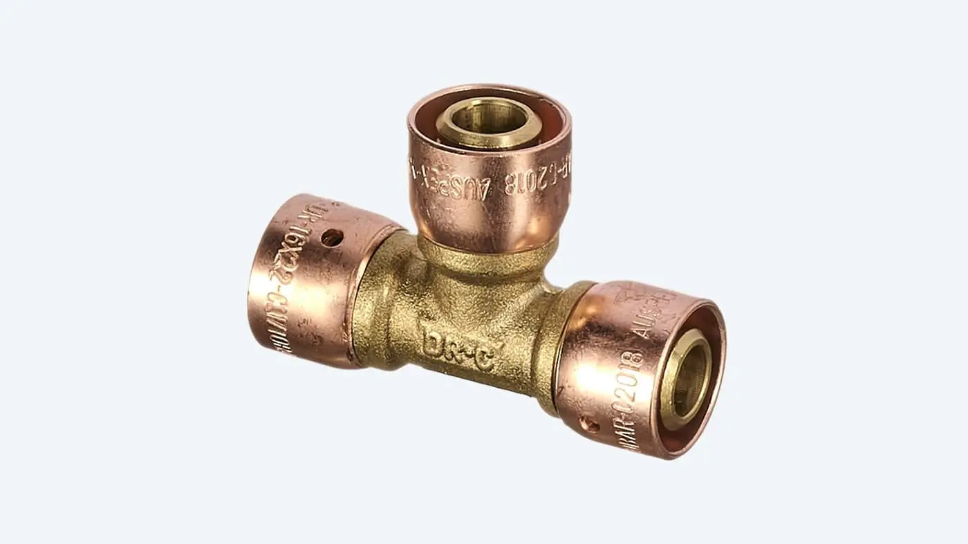 T-shaped brass and copper plumbing fitting with three connection points against white background.