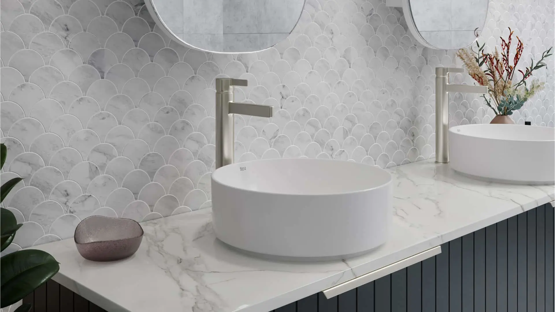 Modern bathroom with white vessel sinks on marble countertop, scalloped tile backsplash, and brushed nickel faucets.