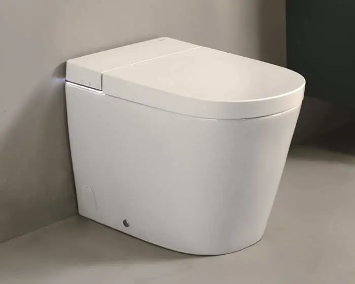 White modern floor-standing toilet with a square seat lid and small control buttons on the side, set against a grey wall.