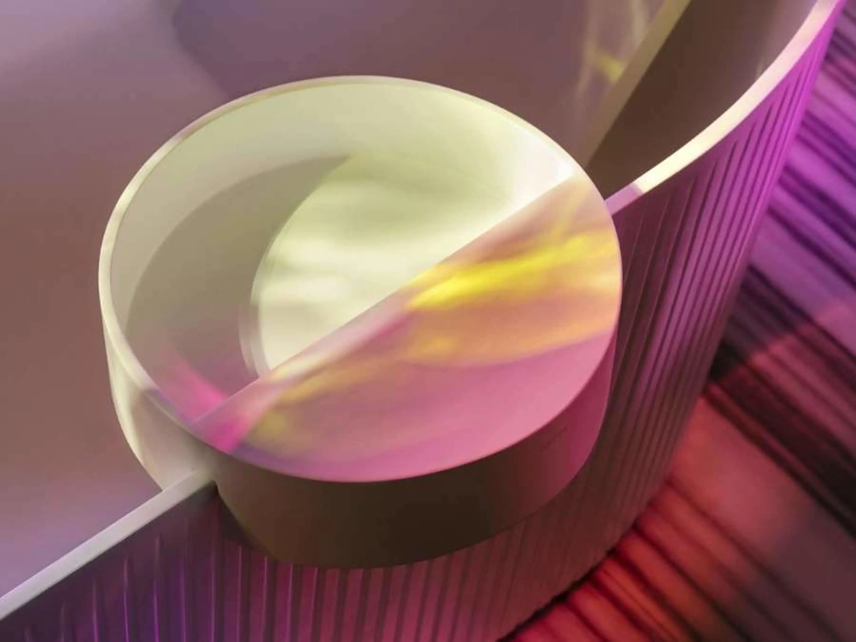 White ceramic basin with colorful pink and yellow light reflections in a purple-lit environment.