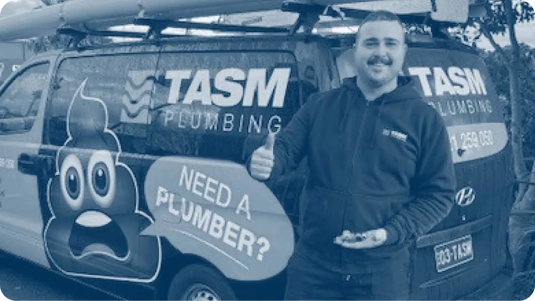 A plumbing service van with someone giving thumbs up beside it.