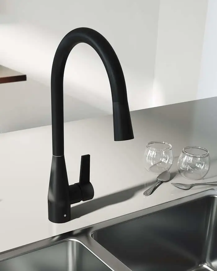 Modern black kitchen faucet with high curved neck above stainless steel sink, with two glass bowls nearby.
