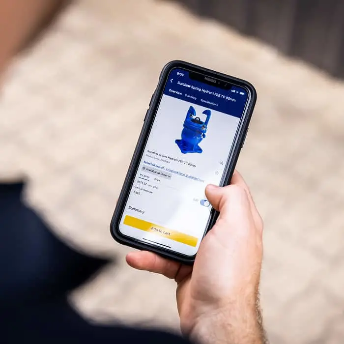 Hand holding smartphone displaying a blue 3D printed figurine product page with "Add to Cart" button visible.