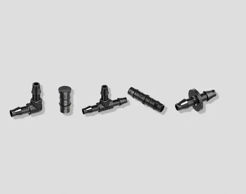 Five black metal plumbing or industrial pipe fittings arranged in a row on a light gray background.