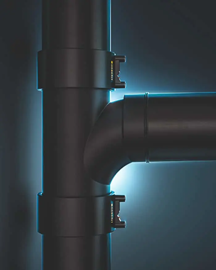 Black plumbing pipes with a curved joint connector, illuminated by blue backlighting against a dark background.