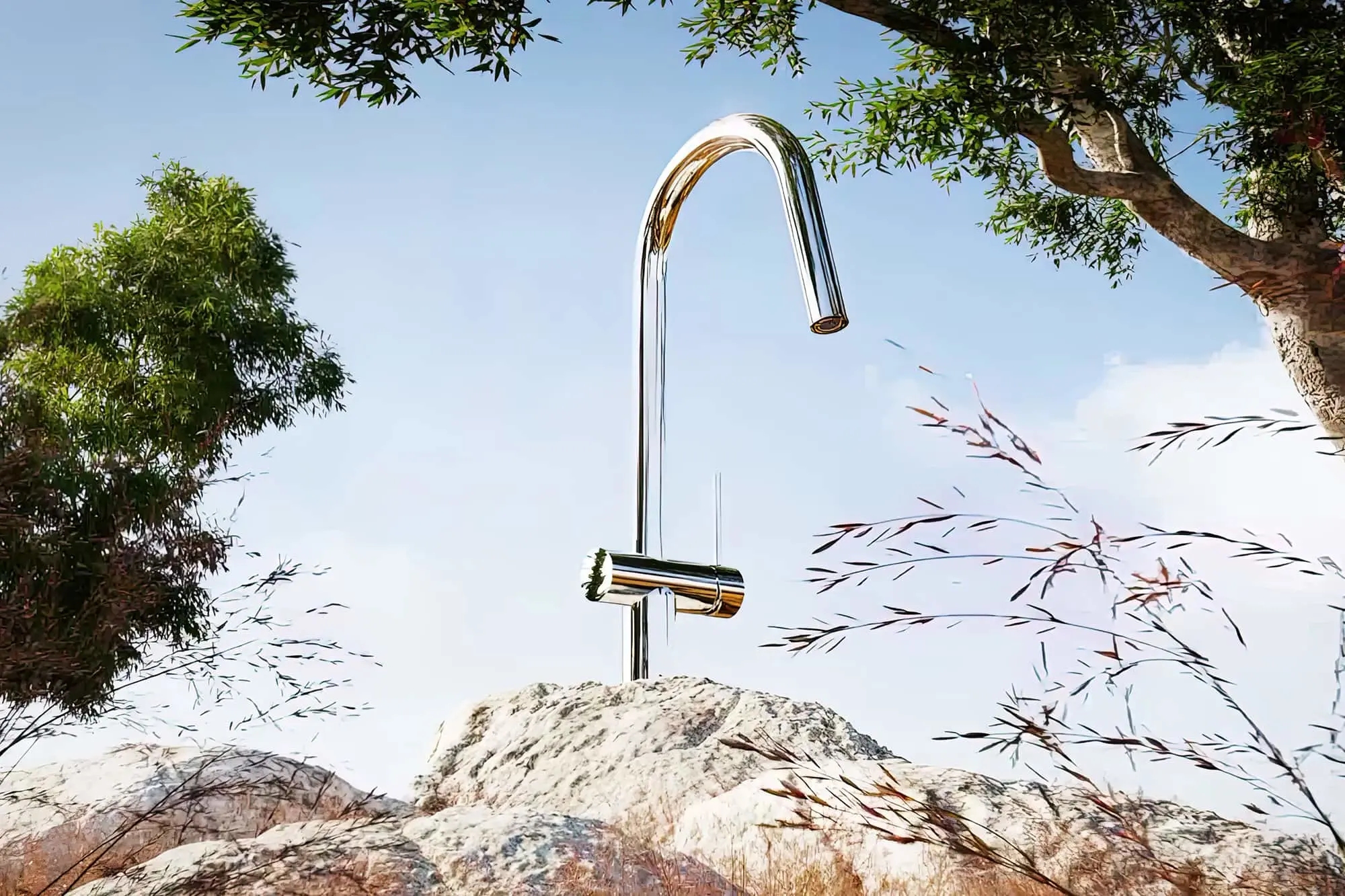 Modern chrome outdoor faucet mounted on stone, surrounded by trees and grasses against a blue sky.
