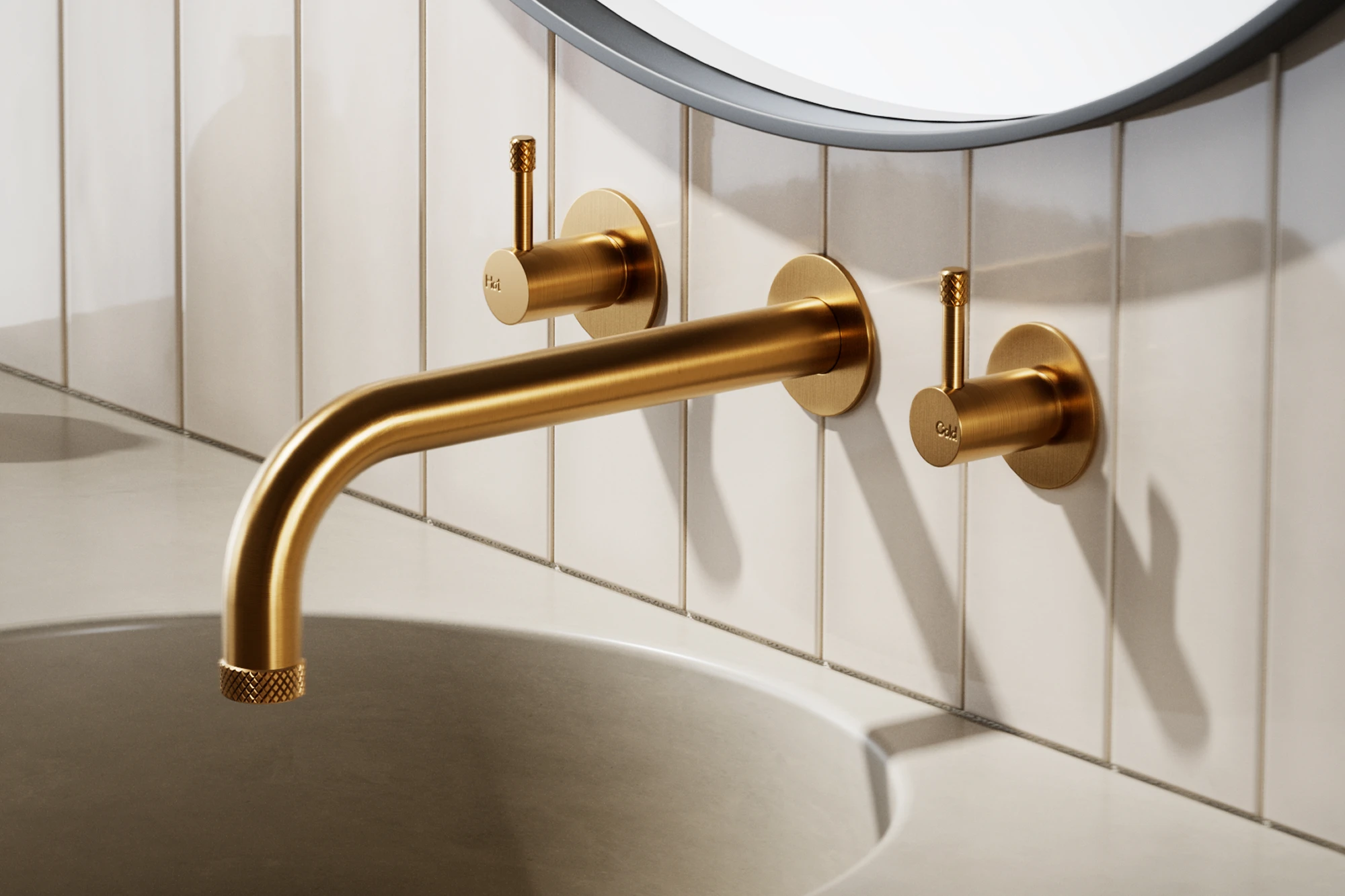 Gold wall-mounted bathroom faucet with hot and cold knobs on white tiled wall above a sink, with circular mirror visible.