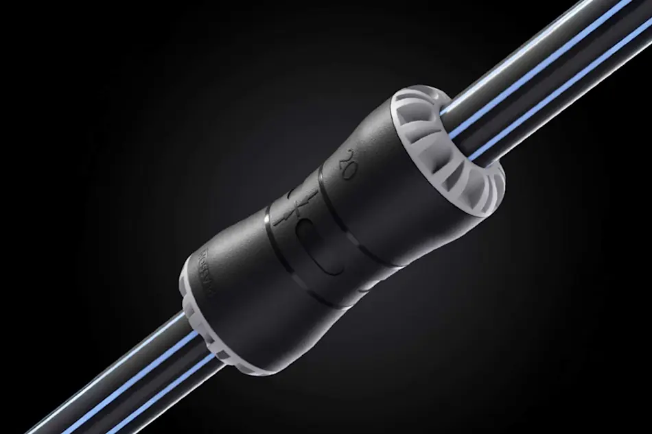 Black cylindrical connector joining cables with blue stripes, featuring white end caps and control buttons on black background.