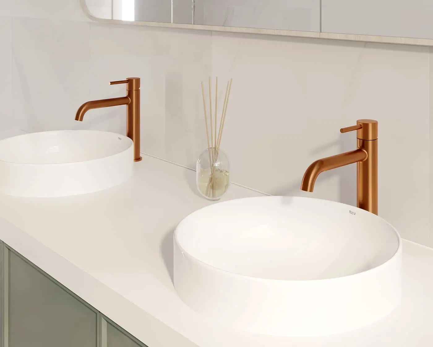 Modern bathroom vanity with two white vessel sinks, bronze faucets, and a reed diffuser on white countertop.