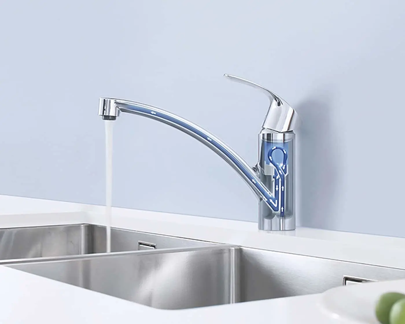 Chrome kitchen faucet with running water over stainless steel double sink, showing internal blue water flow mechanism.
