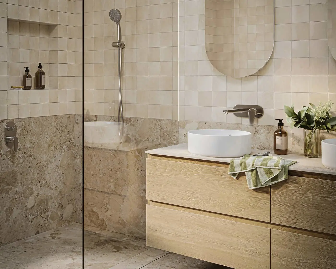 Modern bathroom with beige tiles, glass shower, round white vessel sink on wood vanity, and round mirror.