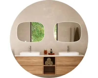 Modern bathroom with dual sinks, wooden vanity, and two rounded mirrors showing greenery outside