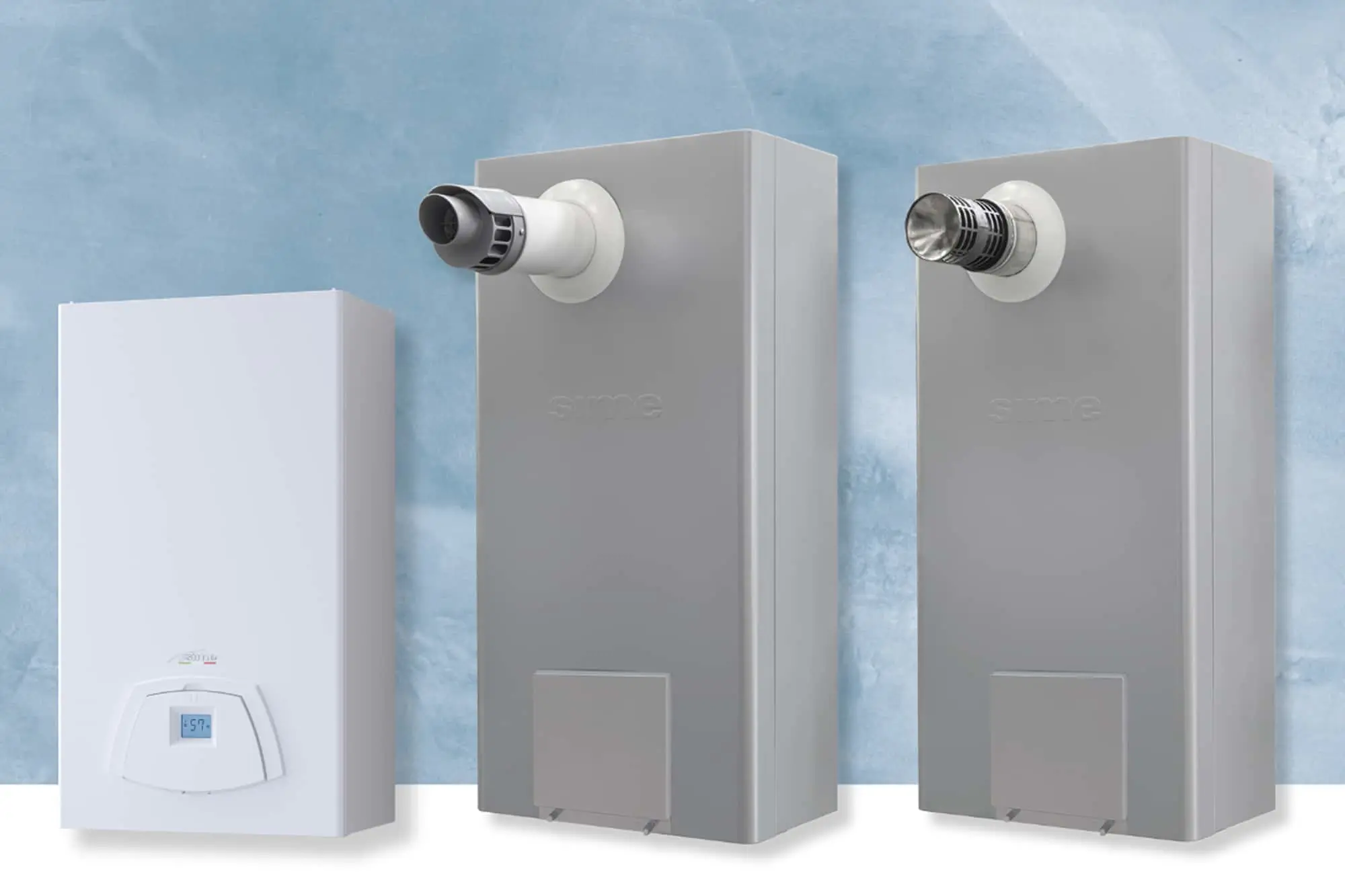 Three home heating units against a blue wall - one white with digital display and two gray with ventilation pipes.