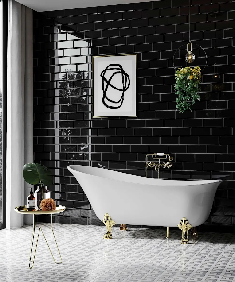 Modern bathroom with white clawfoot tub, black tile walls, abstract art, hanging plant, and gold accents.