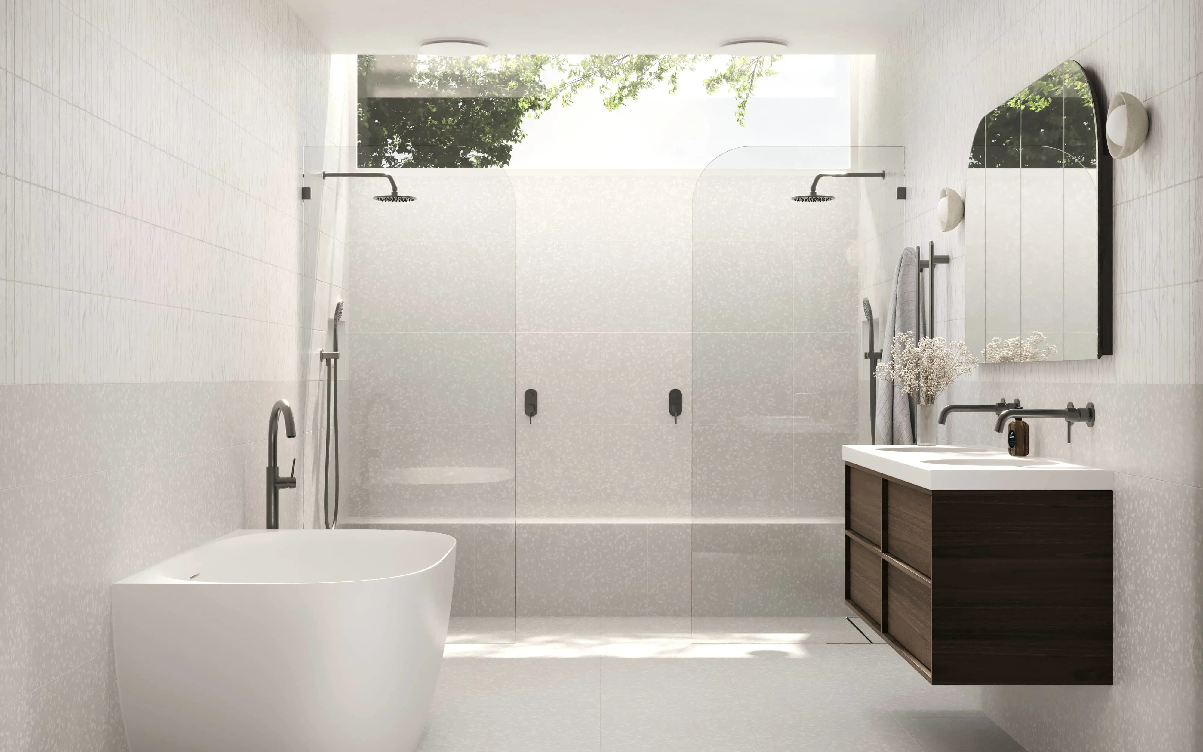 Modern white bathroom with freestanding tub, double shower, wooden vanity, and skylight showing trees above.