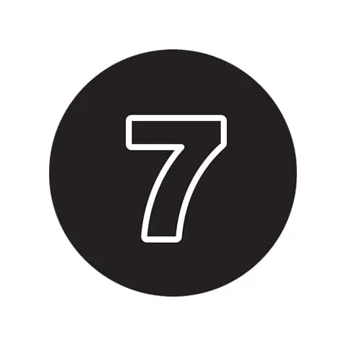 White outline of number 7 on a black circular background