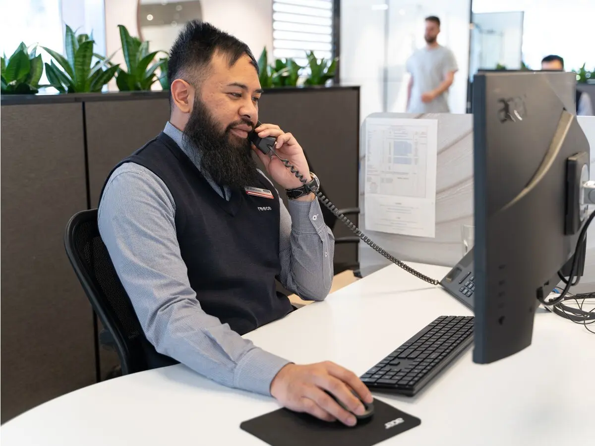 A staff member helping a customer with a product recall