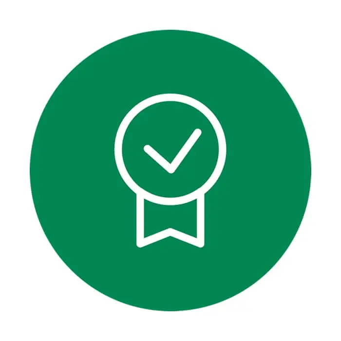 Green circular icon with white checkmark inside a circle and ribbon, representing achievement or certification.