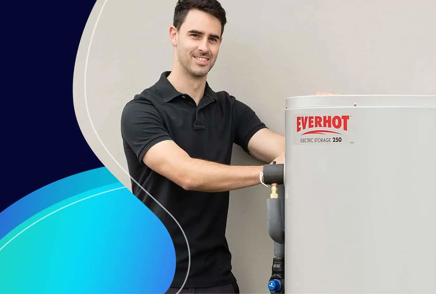 A man in a black polo shirt stands next to an Everhot Electric Storage 250 hot water unit, smiling at the camera.