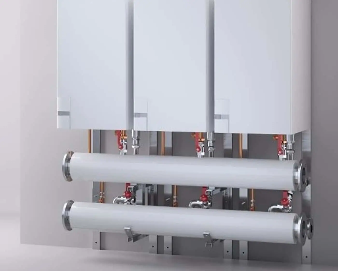 Three white wall-mounted boilers connected to horizontal pipes with red valves and copper piping visible behind.