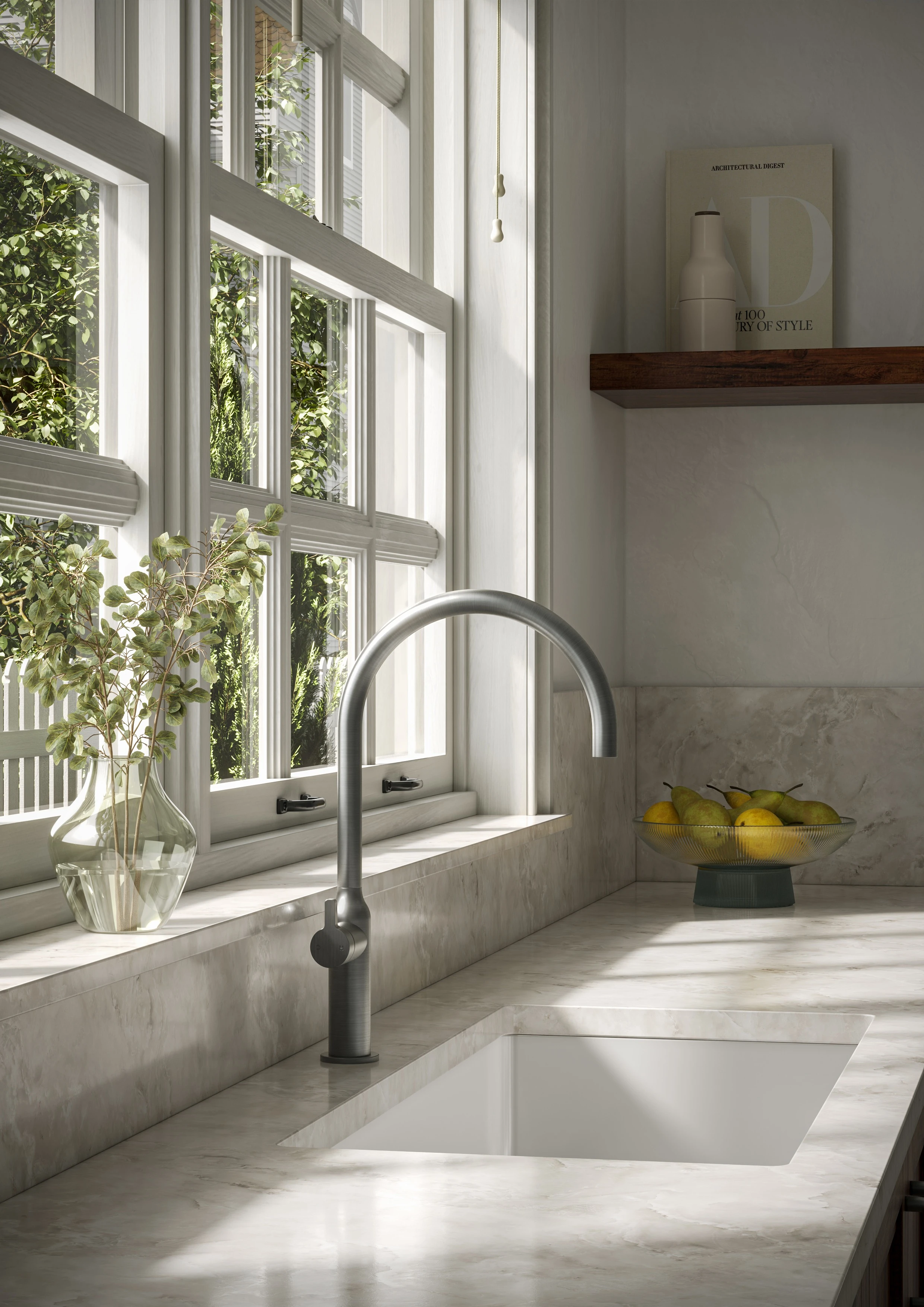 Kitchen sink area with a silver arc faucet, marble countertop, white undermount sink, and a bowl of pears near a large window.