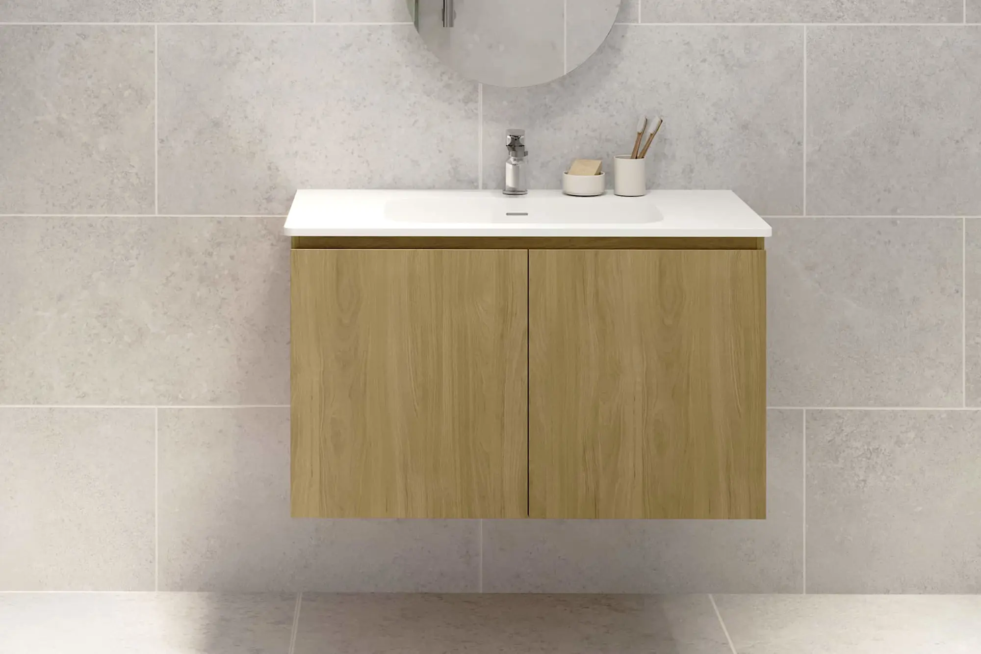 Modern bathroom vanity with wooden cabinet, white sink, and minimalist accessories against light gray tiled wall.