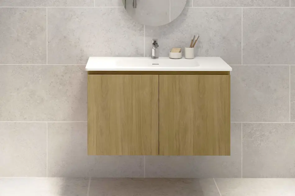 Modern bathroom vanity with wooden cabinet, white sink, and minimalist accessories against light gray tiled wall.