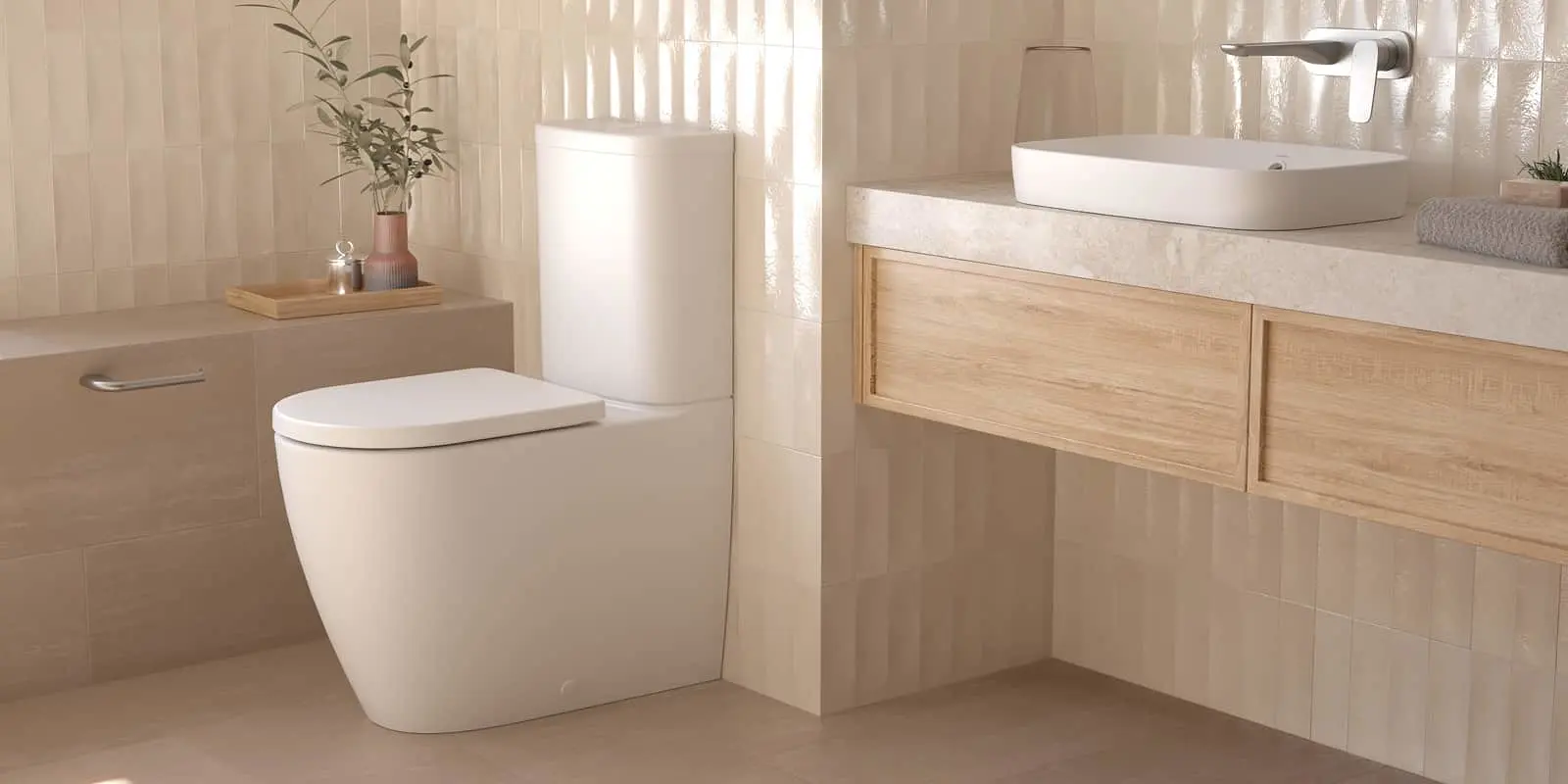 Modern bathroom with white toilet, wooden vanity with vessel sink, and beige tiled walls featuring small potted plant.
