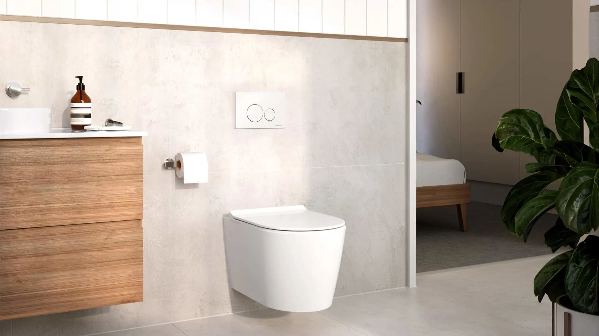Modern bathroom with wall-mounted white toilet, wooden vanity, cream walls, and green plant visible in corner.