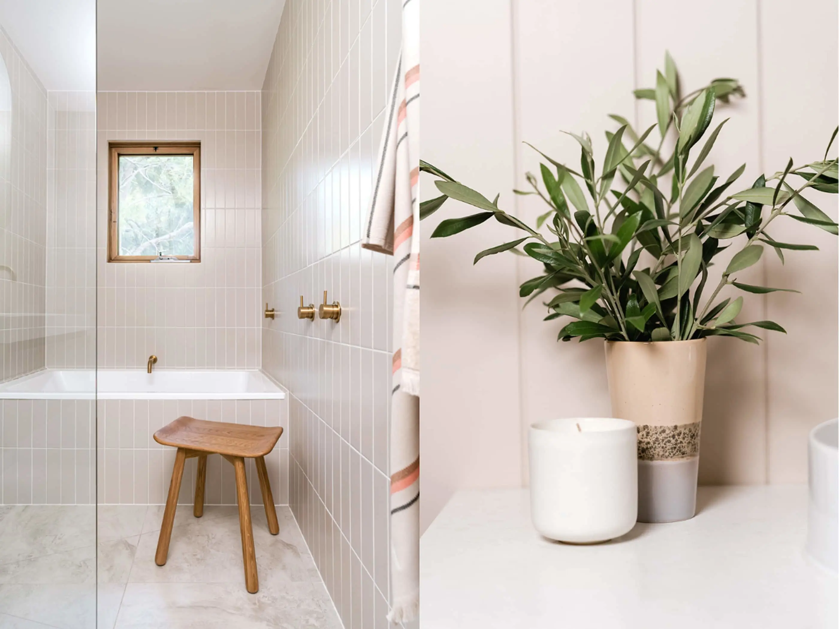 Modern bathroom with white tiled walls, wooden stool, and decorative plant in ceramic pot next to white candle.