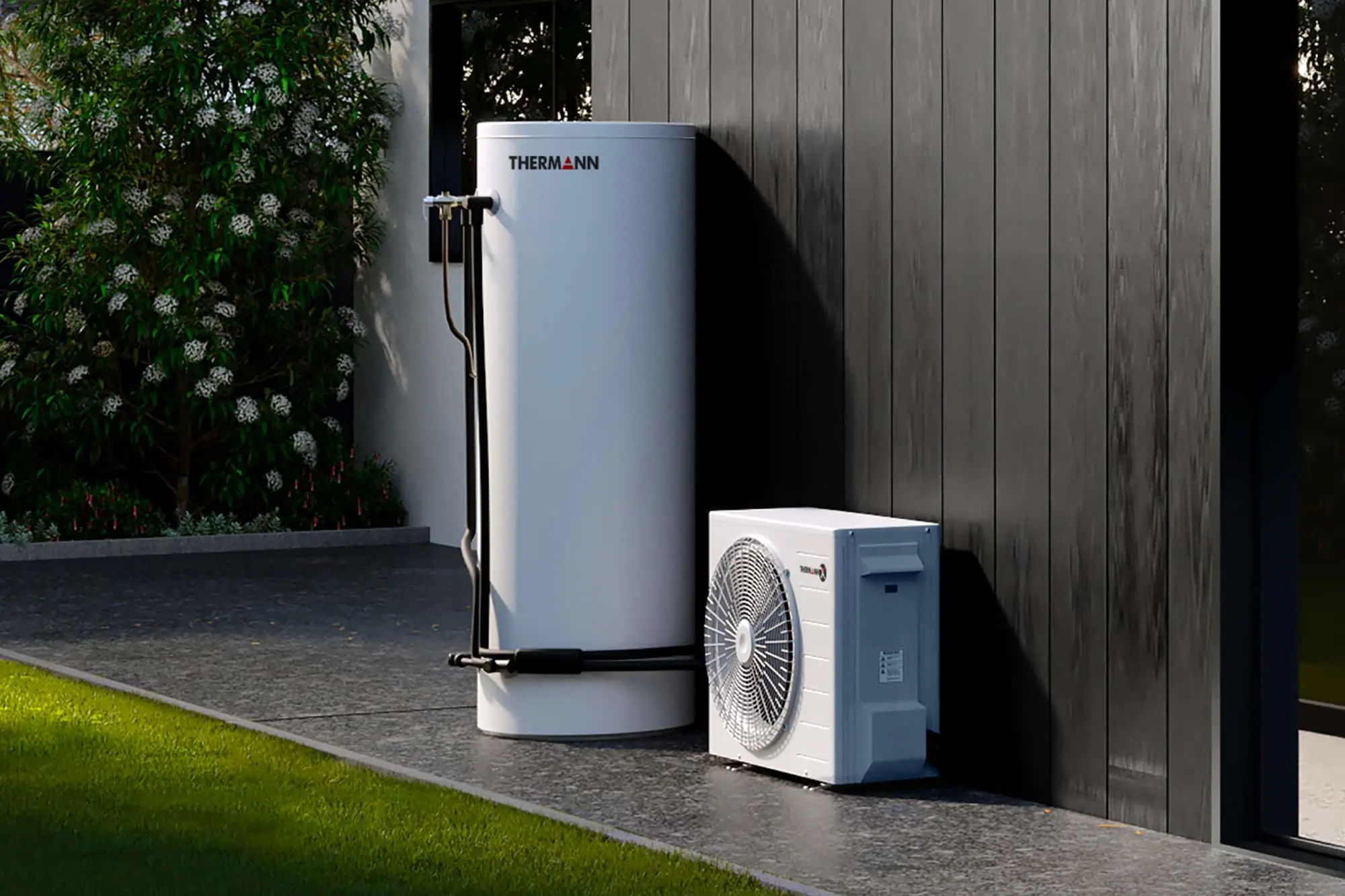 Thermann branded white hot water tank and heat pump unit installed outdoors against a dark grey wall.