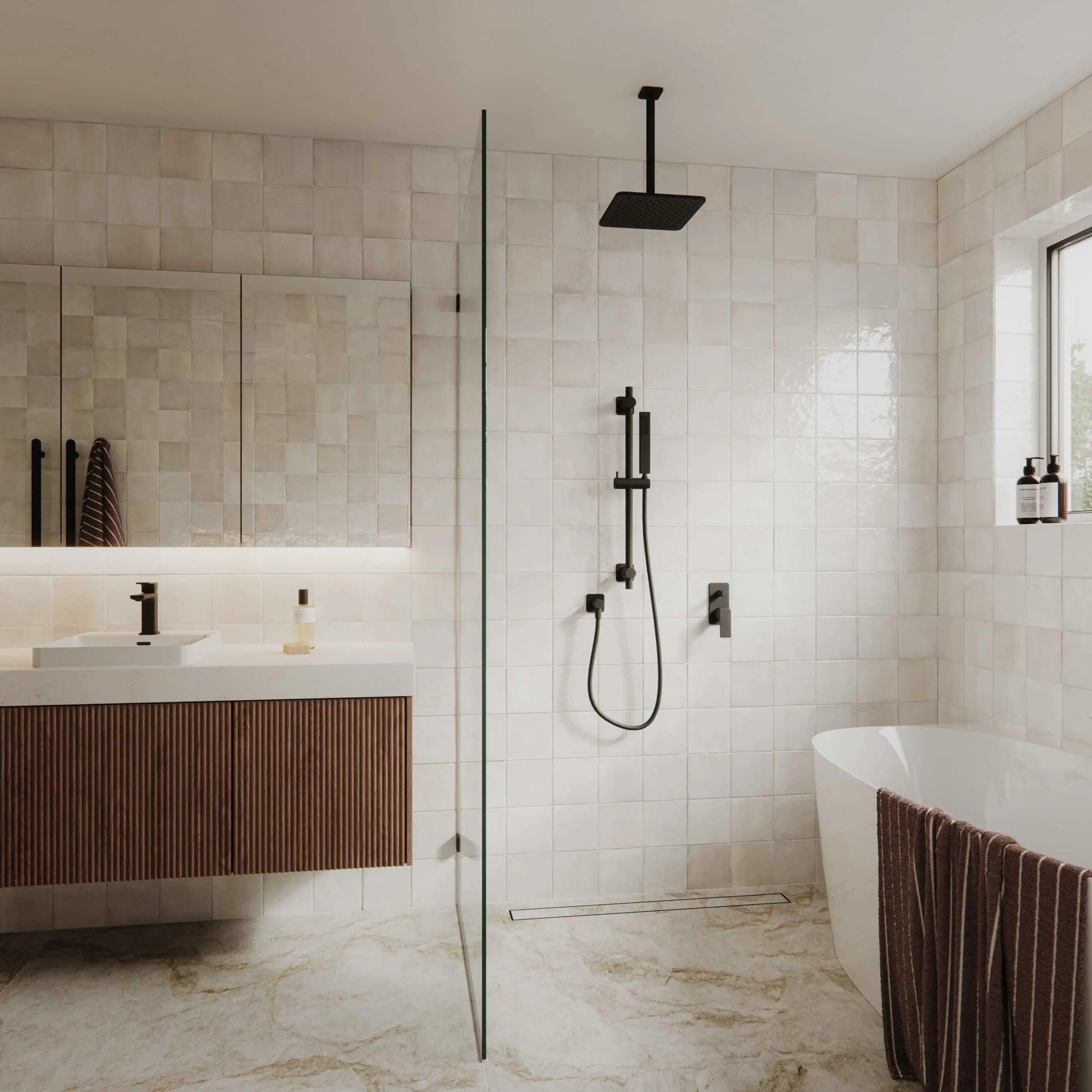 Modern bathroom with cream tile walls, glass shower, black fixtures, wooden vanity, and freestanding bathtub on marble floor.