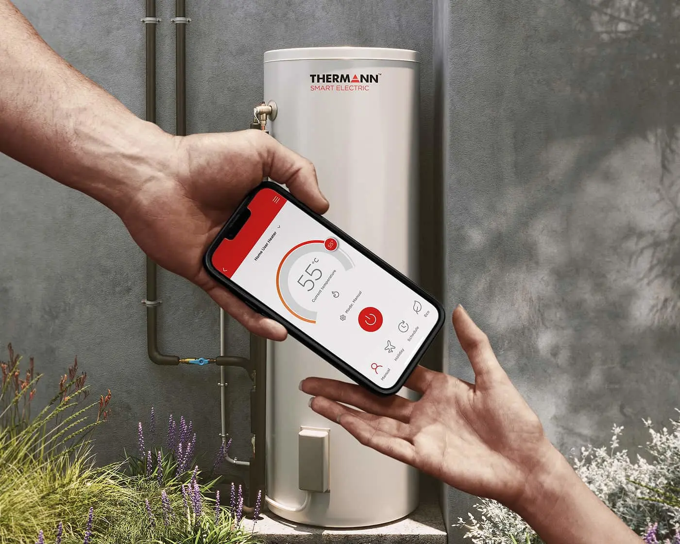 Hand controlling Thermann Smart Electric water heater with smartphone app showing 55°C temperature setting.