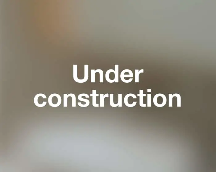 Blurred beige and grey background with white bold text reading "Under construction" in the center.