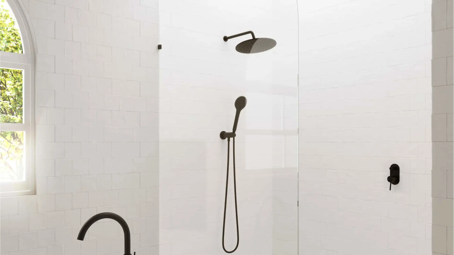 Modern white tiled shower with bronze rainfall showerhead, handheld sprayer, and arched window letting in natural light.