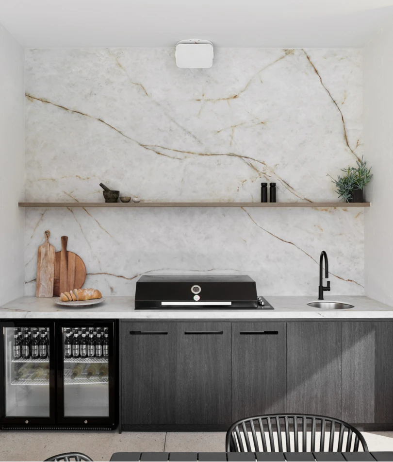 Modern kitchen with white marble backsplash, dark cabinets, black appliance, wooden shelf, and small beverage fridges.