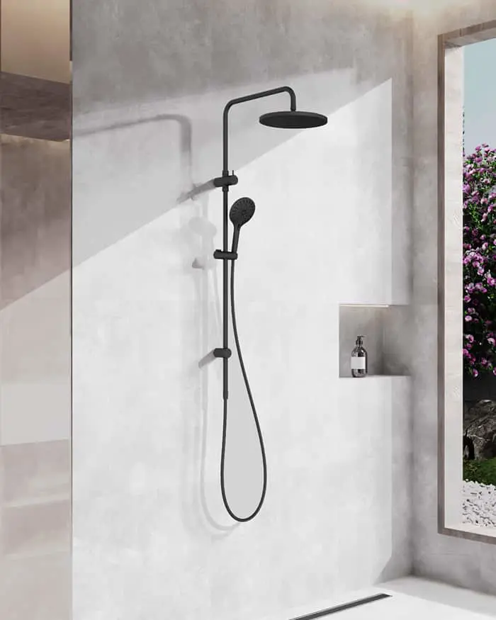 Modern black shower system with overhead rain shower and handheld sprayer mounted on minimalist concrete wall.